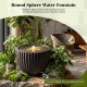 Round sphere water fountain with realistic stone look, curved ridges, and LED lights for tranquil garden ambiance.