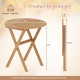 Folding outdoor side table with slatted acacia wood top and X-shaped structure, perfect for indoor or outdoor use.