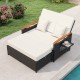 Outdoor wicker daybed with white cushions, adjustable backrest, and storage ottoman for patio relaxation.