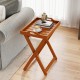 Portable outdoor wood tray table with folding frame, featuring a slatted design and side handles for easy serving.