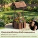 Outdoor wooden wishing well planter bucket with rustic burnt-like finish, perfect for growing flowers in your garden.