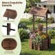 Outdoor wooden wishing well planter with a rustic burnt-like finish, featuring a protective roof and decorative handle.