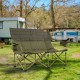 Oversized green camping loveseat with cup holders, thick padding, and sturdy metal frame for outdoor relaxation.