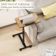 Overbed rolling food tray table with 360° swivel tabletop, adjustable height, and wheeled base for easy mobility.