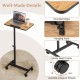 Overbed rolling food tray table with adjustable height, 360° rotating top, and sturdy metal frame for versatile use.