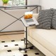 Gray overbed rolling table with adjustable height, 360° rotating tabletop, and wheeled base for versatile use.