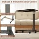 Overbed table with walnut finish, sturdy H-shaped base, and lockable rolling wheels for versatile home and hospital use.