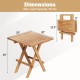Patio folding side table with slatted teak wood top, X-shaped legs, and compact design for easy storage and portability.