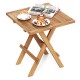 Patio folding side table made of teak wood with slatted tabletop, ideal for camping or backyard use.