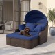 Patio PE rattan daybed with retractable canopy and soft navy cushions, perfect for relaxing in the garden or poolside.