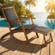 Folding lounge chair with acacia wood frame and PE rattan, perfect for poolside relaxation and outdoor comfort.