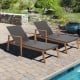 Patio rattan lounge chairs with adjustable backrests, solid acacia wood frame, perfect for poolside relaxation.