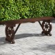 Rustic wood bench with wagon wheel base, made of durable fir wood, perfect for backyard or garden seating.