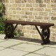 Patio rustic wood bench with wagon wheel base, showcasing slatted seating and sturdy support, ideal for front porch use.
