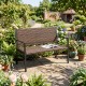 Brown rattan loveseat with soft sponge seat, ideal for patio relaxation, featuring a robust metal frame and armrests.