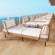 Patio wicker daybed in boho style with white cushions, perfect for outdoor relaxation and seating for two.