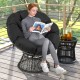 Black PE Wicker Papasan chair with thick removable cushion, featuring a 360° swivel for indoor or outdoor relaxation.