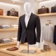 Plastic half body male mannequin with adjustable arms and head, ideal for displaying suits and shirts in retail settings.