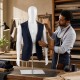 Plastic half body male mannequin with adjustable arms and head, ideal for displaying suits and clothing in stores.