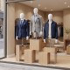 Half body male mannequin in a clothing store display, featuring adjustable head and arms for versatile styling.