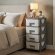 Gray plastic storage organizer with compact drawers, perfect as a bedside table for maximizing space and easy access.