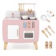 Close-up of pink wooden play kitchen set showing utensils and storage hooks, designed for kids' imaginative cooking.