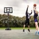 Portable basketball hoop with adjustable height, shatterproof backboard, and stability features for outdoor play.