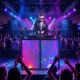 Portable DJ booth with black scrims, featuring a ventilated tabletop and removable shelves for versatile setups.