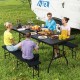 Portable folding camping table in black set for a meal outdoors, showcasing its sturdy design and ample seating for.