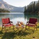 Red portable folding camping chairs with bamboo frames, set by a lake for outdoor leisure and picnics.