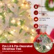 Snow flocked pre-lit artificial Christmas tree with red berries and warm white LED lights for festive elegance.