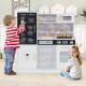 Children playing with a white pretend play kitchen featuring a sink, oven, and utensils for imaginative cooking fun.