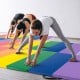 Colorful tri-folding gymnastics tumbling mat with kids practicing yoga and stretching on a soft, durable surface.
