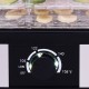 Close-up of the adjustable thermostat on a 5 tray food dehydrator, ranging from 104°F to 158°F for efficient drying.