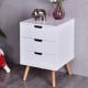 White wood side end table with three drawers and oak legs, perfect for living room or bedroom storage.