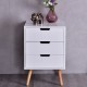 Front view of a stylish white wood nightstand with three drawers and oak legs, ideal for modern living room decor.