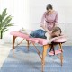Foldable pink facial spa bed with adjustable height, used for massage and facial care, featuring a comfortable design.