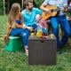Rattan outdoor storage box with zippered liner, used as a coffee table, perfect for backyard gatherings and storage.
