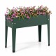 Elevated green metal gardening box with legs, featuring flowers, for easy planting and excellent weather resistance.