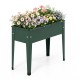 Elevated green metal gardening box with legs, featuring flowers, designed for easy planting and healthy growth.