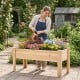 Elevated wooden planter box filled with colorful flowers, ideal for growing herbs and vegetables in any outdoor space.