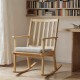 Natural solid rubber wood rocking chair with padded seat and ergonomic backrest, ideal for reading and relaxation.
