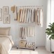 Double-rod rolling clothes rack with extendable top rod and adjustable height, ideal for laundry rooms and bedrooms.