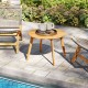 Round outdoor acacia wood side table with slatted tabletop, ideal for patio or poolside use, showcasing natural charm.