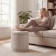 Round storage ottoman footrest in beige with removable lid, featuring acacia wood frame and hidden storage for.