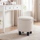 Round beige storage ottoman with removable lid, upholstered in linen fabric, ideal for footrest or side table use.