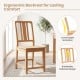 Natural rubber wood dining chair with ergonomic hollowed backrest for comfort and breathable design in a cozy setting.