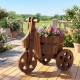 Rustic wood tricycle planter barrel with flowers, crafted from fir wood, ideal for outdoor decoration and plant display.