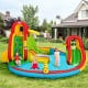 Colorful kid's inflatable water slide bounce house with climbing wall and splash pool for outdoor summer fun.
