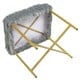 Underside view of gray faux fur ottoman stool with golden metal legs, highlighting its compact design and sturdy.